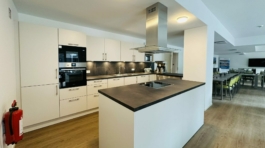 Weiße Küche mit Ofen und Dampfgarer